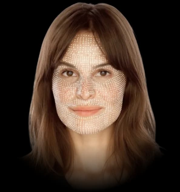 A 3D face scan — a grid of measurement points mapped across a face, framed in close so the mesh fades out before the edges